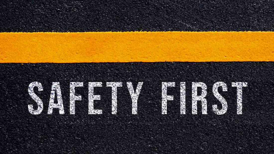 asphalt road with the words safety first painted